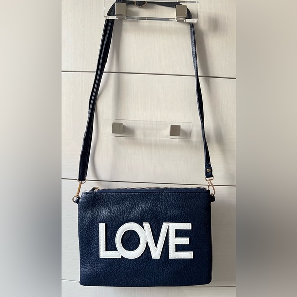 A navy blue shoulder and wristlet, adjustable strap to also wear as a crossbody - Picture 3 of 12